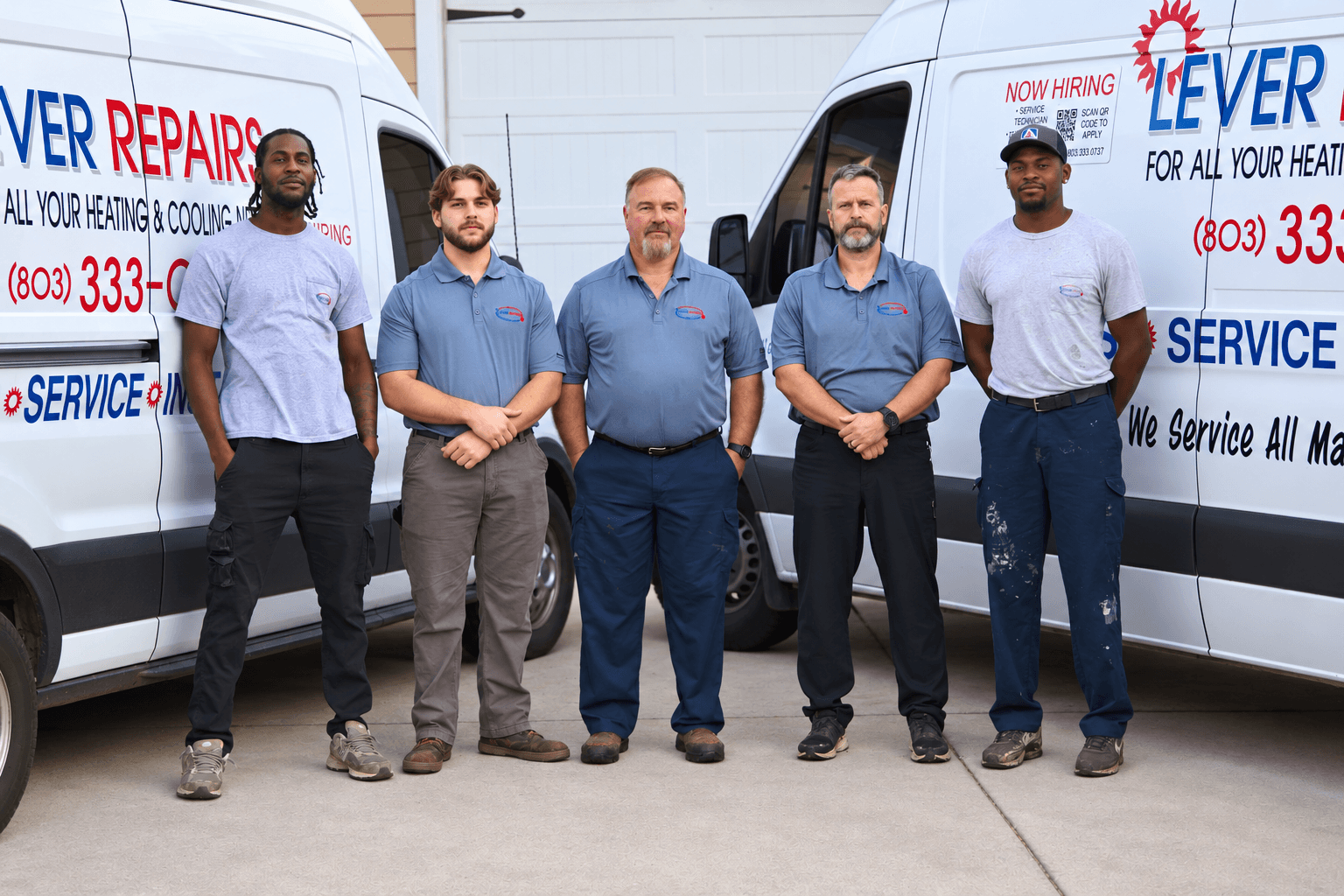 The Lever Repairs crew, five technicians including owner Ed Lever, standing together in front of the company service vans